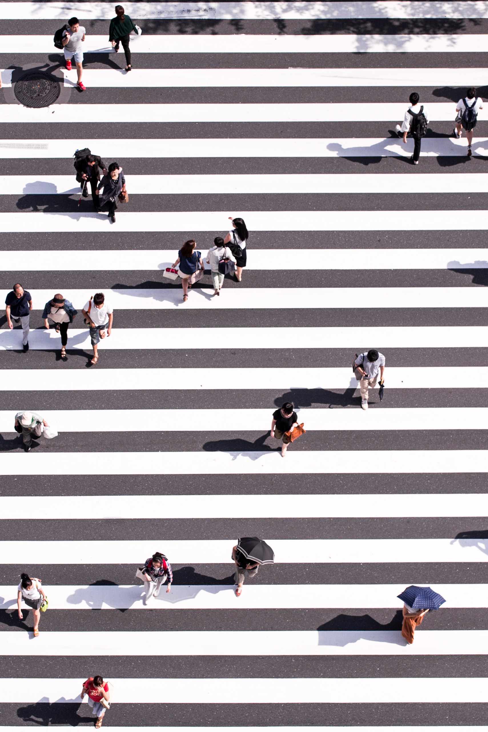 Aerial image of people on a road crossing